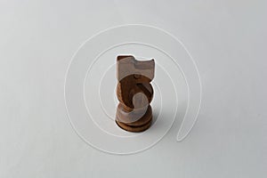 Wooden horse chess figure on grey background