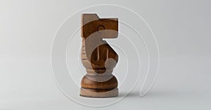 Wooden horse chess figure on grey background