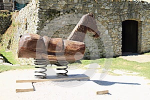 Wooden horse in front of stables on Castle Rabi