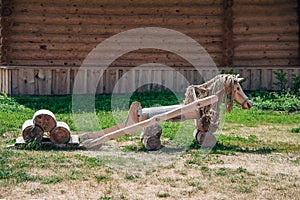 Wooden horse landscape design. Lovingly decorated the area with plants and flowers.