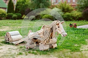 Wooden horse landscape design. Lovingly decorated the area with plants and flowers