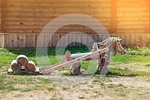 Wooden horse landscape design. Lovingly decorated the area with plants and flowers. Toned
