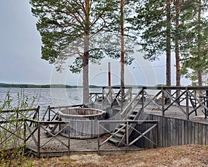 Wooden hot tubs at lakeside in northern Sweden