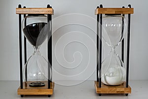 Wooden hourglasses with black and white sand representing yin and yang