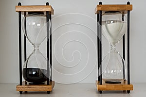 Wooden hourglasses with black and white sand representing yin and yang