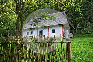 Wooden house behind wooden fence in open air museum near Bardejovske kupele spa resort during summer