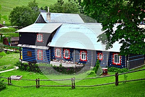 A wooden house with blue, red and white colors in the small town Zdiar near the High Tatras, Slovakia