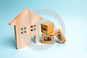 Wooden house and cardboard boxes. The concept of moving to a new home, housewarming. Buying a new home, mortgage