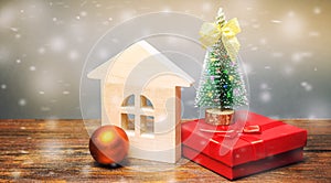 Wooden house, Christmas tree and gifts. Christmas Sale of Real Estate. New Year discounts for buying housing. Purchase apartments