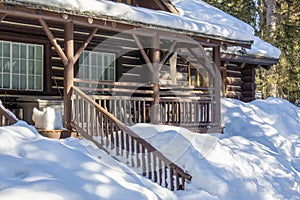 wooden house covered in snow in the early spring woods alberta canada