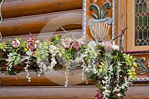 The wooden house is decorated with flowers,