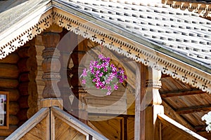 The wooden house is decorated with flowers,