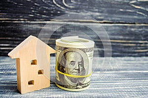 Wooden house and dollars on a blue background. concept of real estate. buying, selling, renting. credit for property. sale apartme