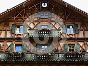 Wooden house facade country-style balcony flowers exterior shutters