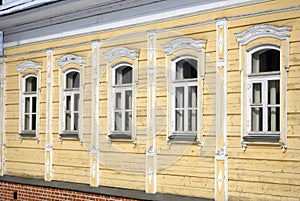 Wooden house facade with five windows