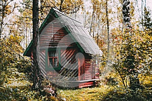 Wooden house in fall forest