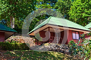 Wooden house with green tiled roof