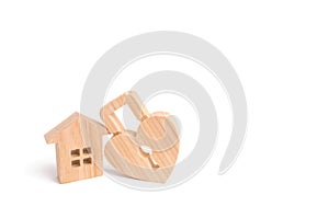 Wooden house with Heart shaped lock on a white background. Love nest, relationships. Buying a house with a young family. Affordabl