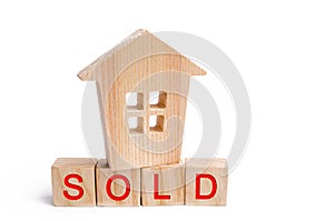 Wooden house with the inscription sold on white isolated background. sale of property, home. affordable housing. sale of