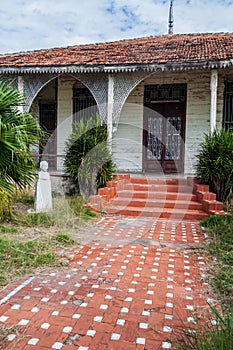 Wooden house with Jose Marti statue in Punta Gorda neighborhood in Cienfuegos, Cu