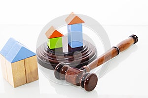 Wooden house and judge gavel on a white background. Is isolated.