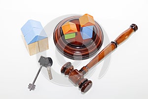 The wooden house and judge gavel on wooden table