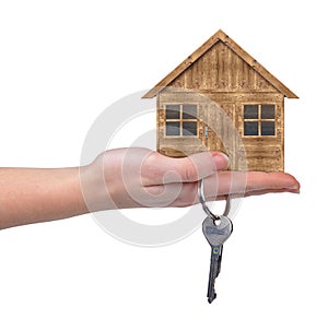 Wooden house with key in hand