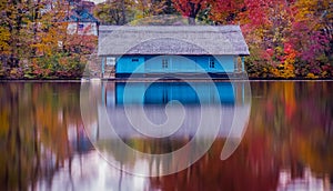 Wooden house on the lake in autumn season