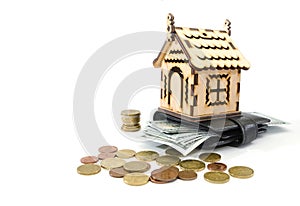 Wooden house, money and wallet on white. Buying real estate and housing on credit. Mortgage credit lending.