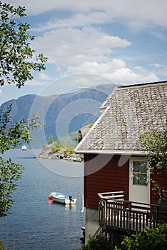 wooden house and mountains on coast of beautiful Aurlandsfjord Flam