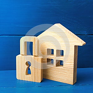 Wooden house with a padlock. Buying a home. House with a lock. Security and safety, collateral, loan for a mortgage. Confiscation