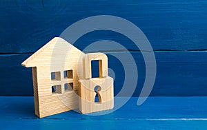 Wooden house with a padlock. House with a lock. Security and safety, collateral, loan for a mortgage. Confiscation of property for