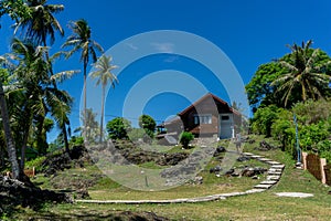 Wooden house on the palm land near the beach. Beach house on the rocky land of Sabang island at Aceh, Indonesia
