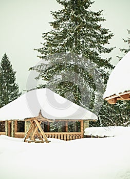 Wooden house in a snowy forest. Hotel. ski resort