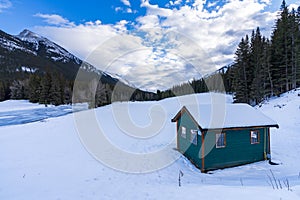 A wooden house in a snowy frozen wasteland.