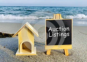 Wooden house stand with a sign auction listings. Selling a house or apartment and property. housing and real estate.