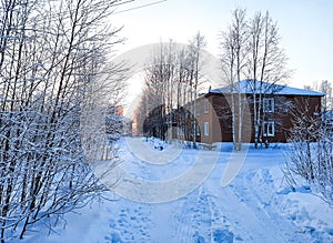 wooden house in the village of oil workers around the winter landscape