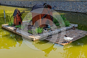 Wooden house for water birds and turtles on lake in city park