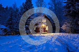 Wooden house in winter forest