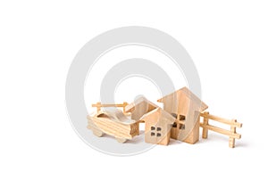 Wooden houses and car on a white background. The concept of possessions, buildings. Purchase and sale of real estate, investment. photo