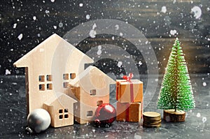 Wooden houses and Christmas tree. Christmas Sale of Real Estate. New Year discounts for buying house. Purchase apartments at a low
