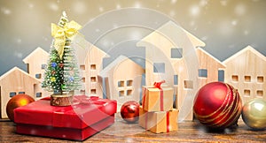 Wooden houses, Christmas tree and gifts. Christmas Sale of Real Estate. New Year discounts for buying housing. Purchase apartments