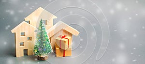 Wooden houses, Christmas tree and gifts. Holiday. Winter vacation. Christmas Sale of Real Estate. New Year discounts for buying