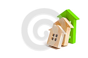 Wooden houses fall on each other like dominoes. the green house stops the fall of other houses. The concept of falling prices
