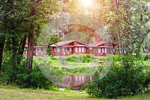 Wooden houses in the forest by the lake