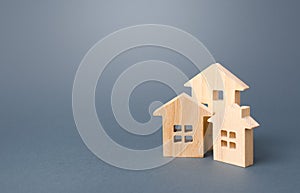 Wooden houses on a gray background. Buy purchase and sale of housing, rental. Community owners of apartments and houses.