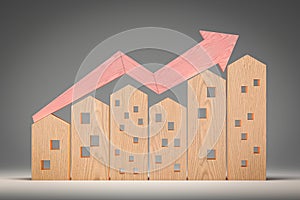 Wooden houses models with red wooden arrows up. Mortgage loan. hypothec. Housing boom, property market growing