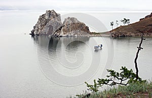 Wooden houses near Baikal on the Olkhon island. Country side, forest and farm field. Beautiful landscape, natural background with