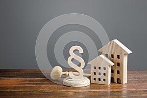 Wooden houses and paragraph figurine with judge hammer. Litigation in housing and real estate disputes. Norms and rules