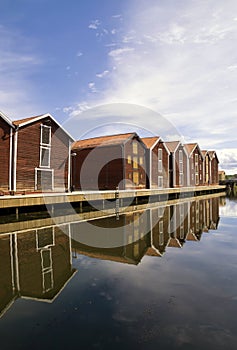 Wooden houses reflecting in the harbour in Hudiksvall